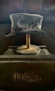 Distressed hat with a feather by Hull & Sons