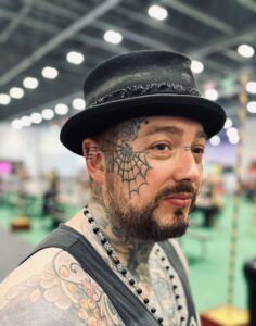 Tattooed man in a Hull & Sons hat