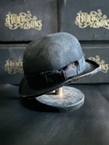 Distressed black bowler hat by Garey Hull