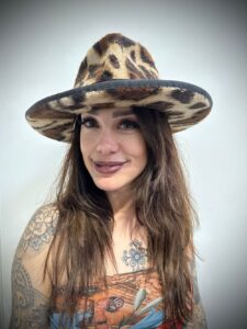 Lady in a Hull & Sons animal print hat